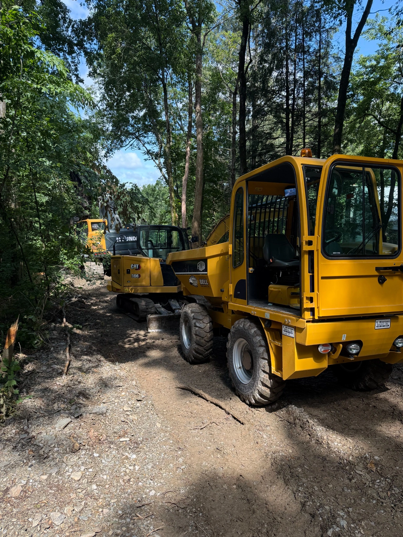 Excavators working on rocky terrain during site preparation